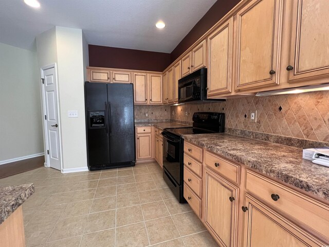 kitchen featuring backsplash, light tile patterned floors, black appliances, and light brown cabinetry