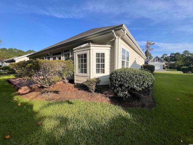 view of side of property featuring a yard