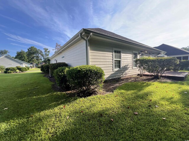 view of side of home featuring a lawn