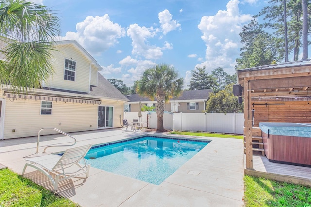 view of swimming pool with a patio area, a fenced backyard, a fenced in pool, and a hot tub