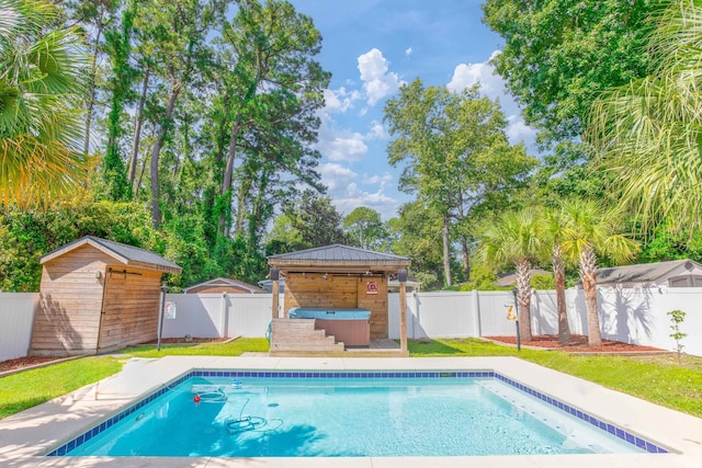 view of swimming pool with a fenced backyard, an outdoor structure, a gazebo, a lawn, and a fenced in pool