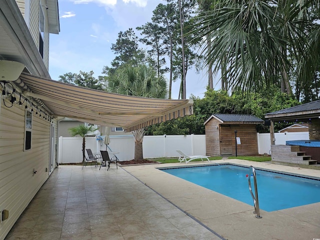 view of swimming pool featuring a patio area, a fenced backyard, a fenced in pool, and a hot tub