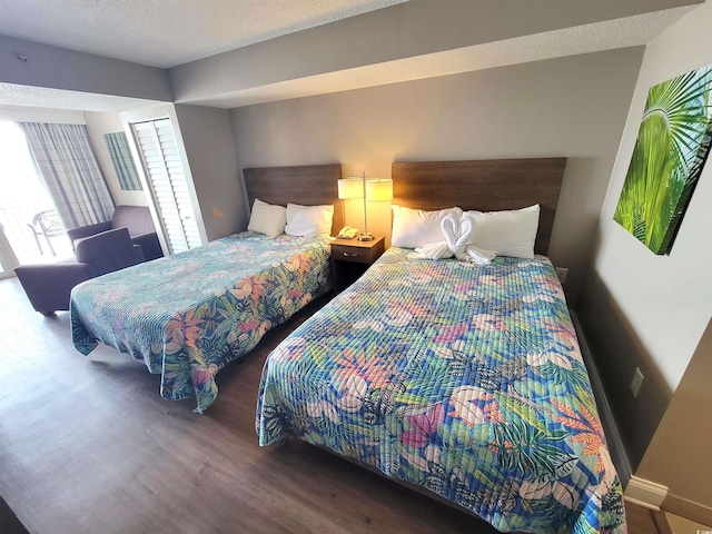 bedroom with hardwood / wood-style floors and a textured ceiling