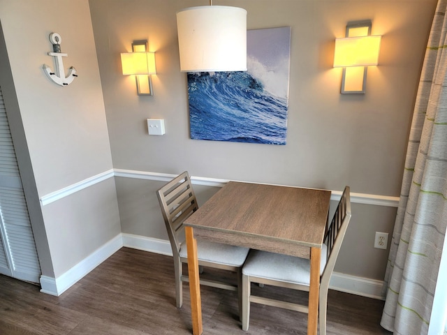 dining space featuring dark wood-type flooring