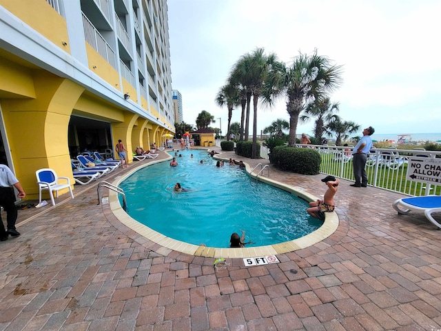 view of swimming pool featuring a patio area