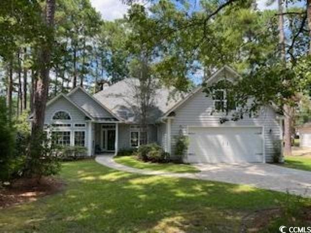 view of front of home featuring a garage and a front yard