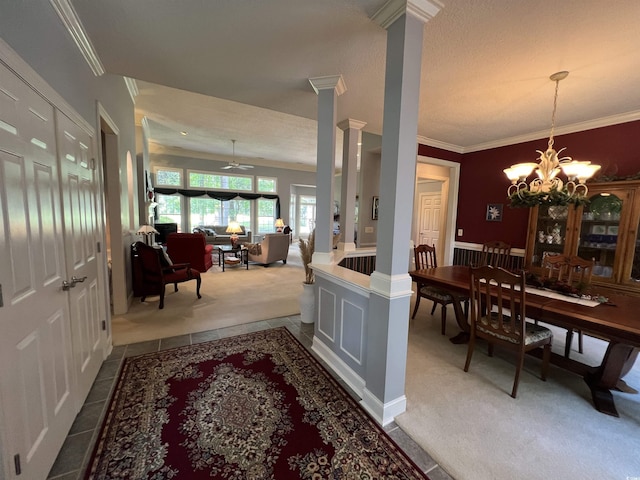 interior space featuring crown molding, tile patterned flooring, and ornate columns