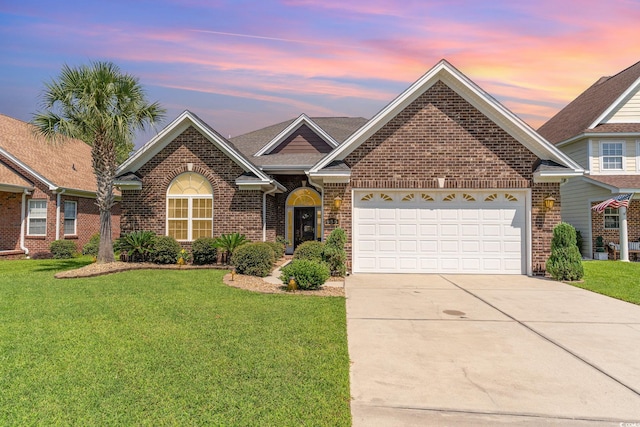 view of front facade featuring a garage and a lawn