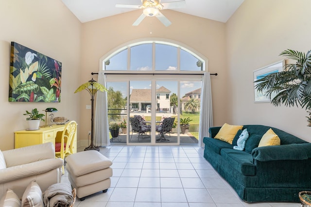 tiled living room featuring a towering ceiling and ceiling fan