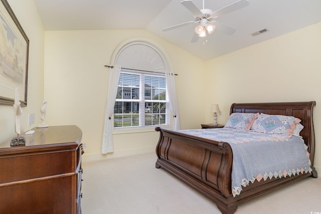 carpeted bedroom with ceiling fan and vaulted ceiling