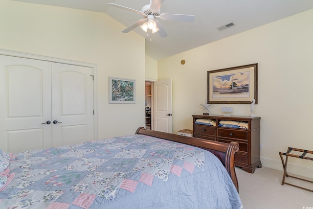 bedroom with ceiling fan, a closet, vaulted ceiling, and light carpet