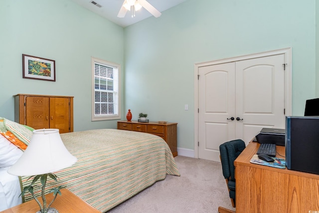 carpeted bedroom with a towering ceiling and a closet