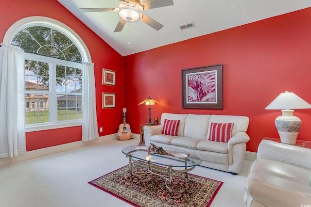 carpeted living room featuring vaulted ceiling and ceiling fan