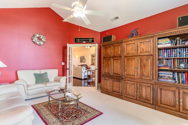 carpeted living room featuring french doors, ceiling fan, and lofted ceiling