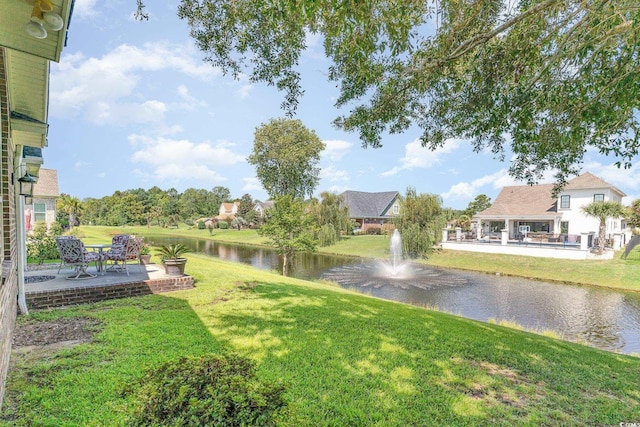 view of yard featuring a water view and a patio area