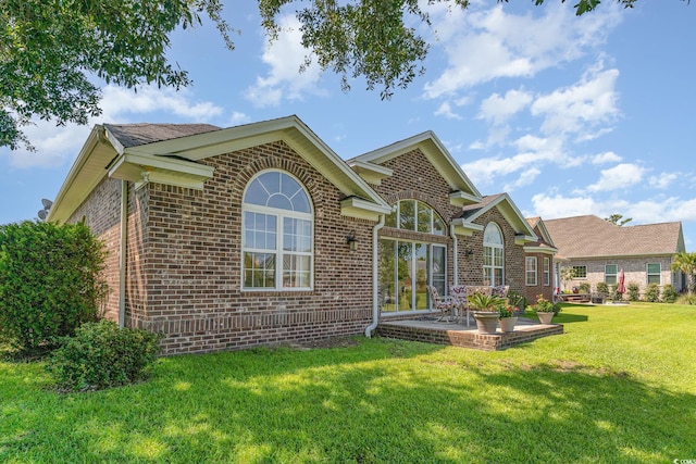 rear view of house with a yard