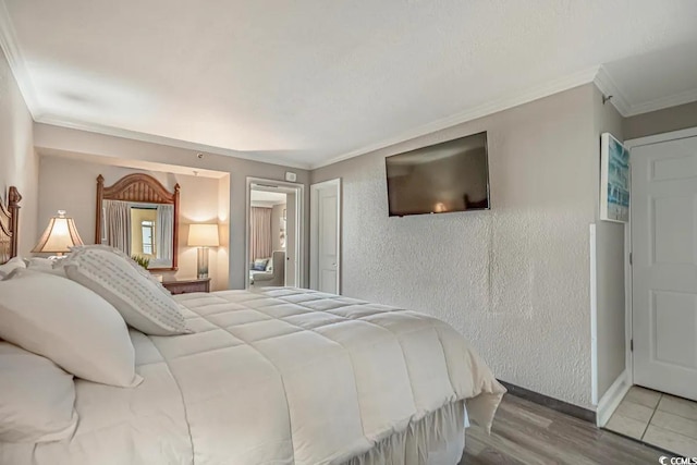 bedroom featuring crown molding and hardwood / wood-style floors