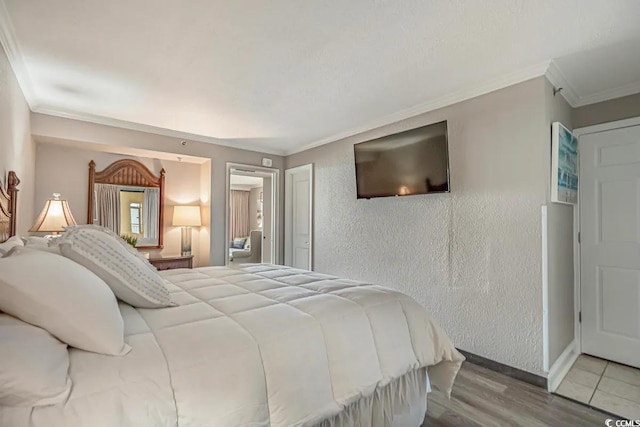 6900 Ocean Blvd N Unit 1410, Myrtle Beach, SC 29572 - bedroom featuring wood finished floors, a textured wall, ornamental molding, and baseboards