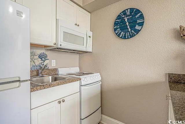 kitchen with sink, white cabinetry, and white appliances