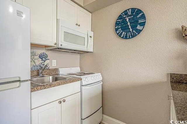 6900 Ocean Blvd N Unit 1410, Myrtle Beach, SC 29572 - kitchen featuring a textured wall, white appliances, white cabinets, and a sink