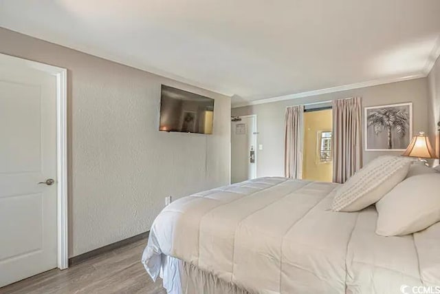6900 Ocean Blvd N Unit 1410, Myrtle Beach, SC 29572 - bedroom with wood finished floors, ornamental molding, and baseboards