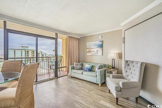6900 Ocean Blvd N Unit 1410, Myrtle Beach, SC 29572 - living room featuring a textured ceiling, light wood-type flooring, expansive windows, and ornamental molding