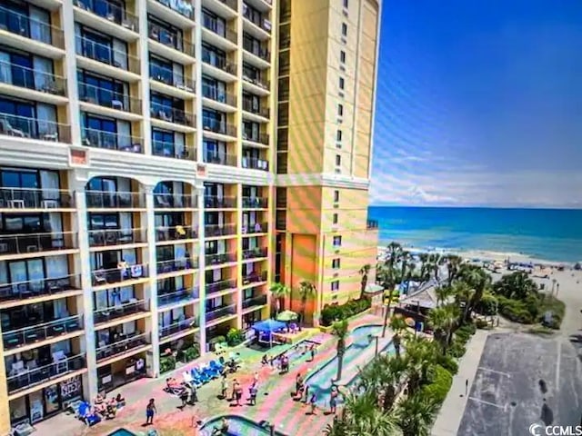 view of building exterior featuring a view of the beach and a water view