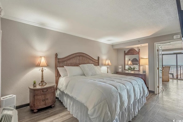 bedroom with ornamental molding and a textured ceiling