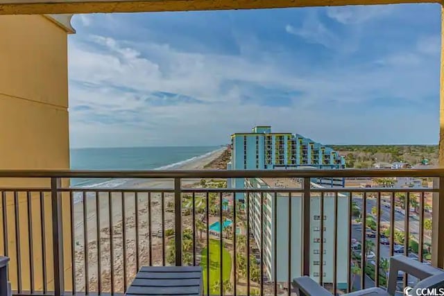 balcony featuring a beach view and a water view