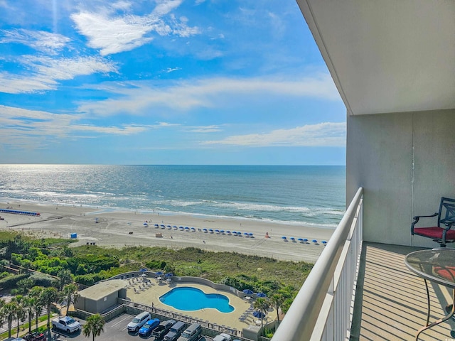 balcony with a water view and a beach view