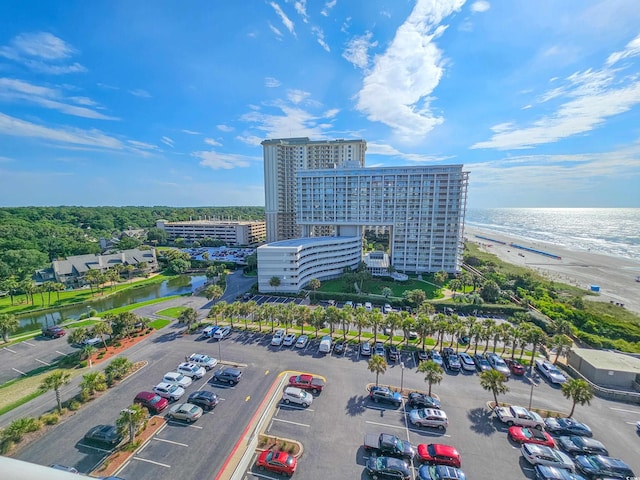 birds eye view of property featuring a water view and a beach view