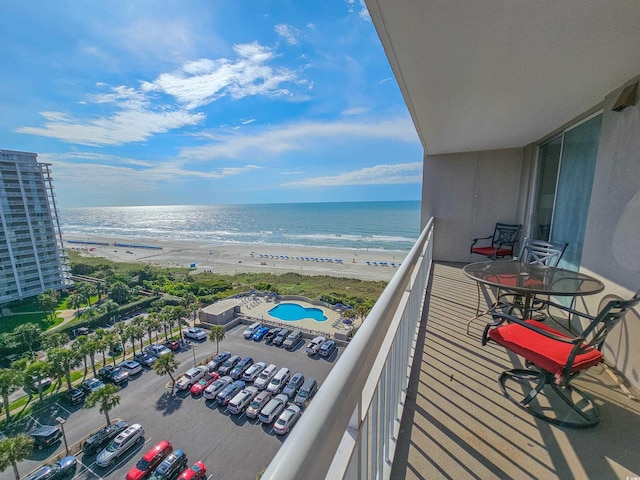 balcony with a water view and a beach view