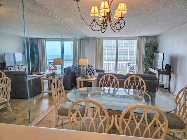 dining area featuring a notable chandelier and a textured ceiling