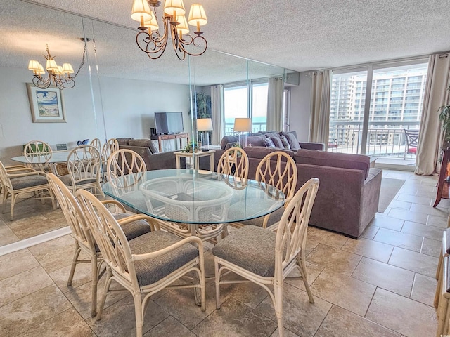 tiled dining room with a notable chandelier and a textured ceiling