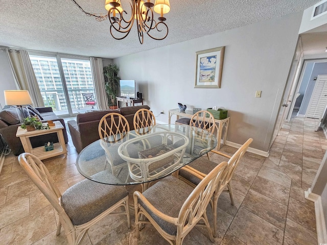 dining room featuring an inviting chandelier and a textured ceiling