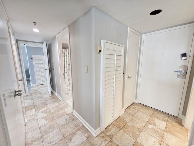 hallway featuring light tile patterned floors