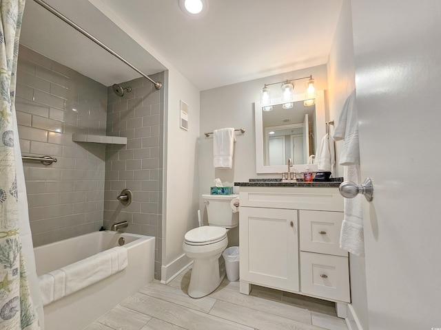 full bathroom with shower / tub combo with curtain, vanity, and toilet