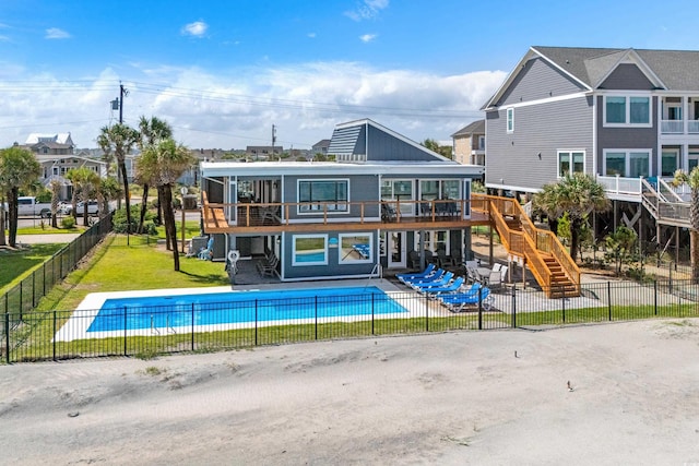 back of property featuring a fenced in pool, stairs, fence, a yard, and a patio area