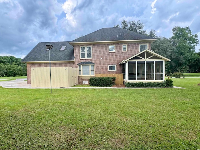 back of house featuring a sunroom and a yard