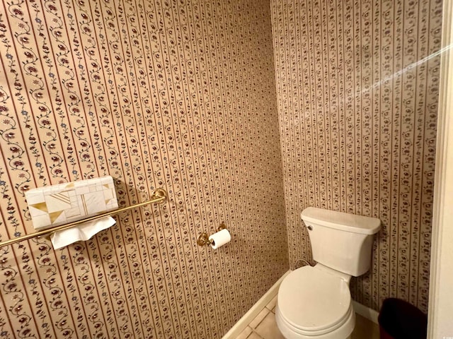 bathroom with toilet and tile patterned floors