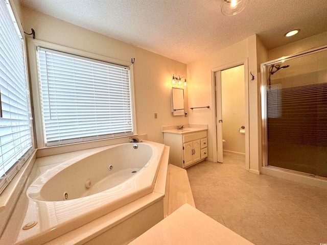 bathroom with independent shower and bath, vanity, a textured ceiling, and tile patterned flooring