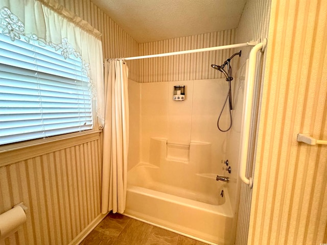 bathroom featuring shower / tub combo with curtain, tile patterned floors, and a textured ceiling