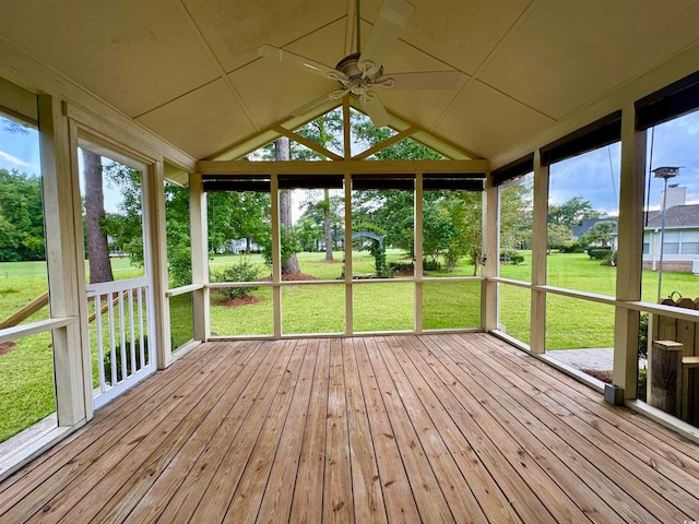 unfurnished sunroom with a wealth of natural light, lofted ceiling, and ceiling fan