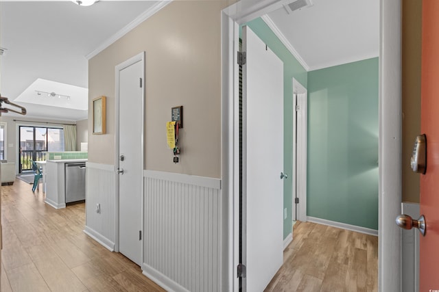 hall featuring ornamental molding and light hardwood / wood-style flooring