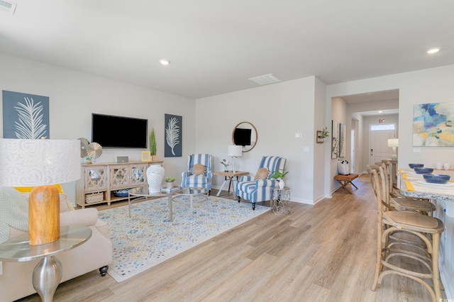 living room with light hardwood / wood-style flooring