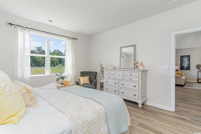 bedroom with light hardwood / wood-style floors