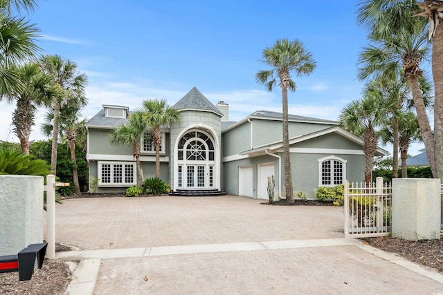 8000 Beach Dr, Myrtle Beach, SC 29572 - exterior space featuring an attached garage, decorative driveway, and fence