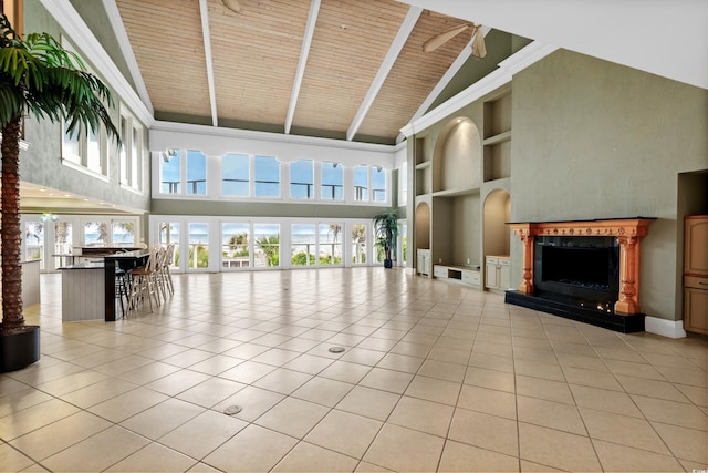 unfurnished living room featuring built in features, beam ceiling, a high end fireplace, light tile patterned flooring, and wooden ceiling