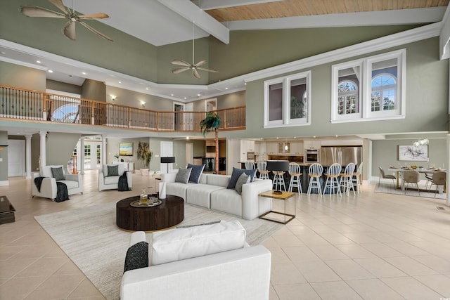 tiled living room featuring beamed ceiling, high vaulted ceiling, and ceiling fan