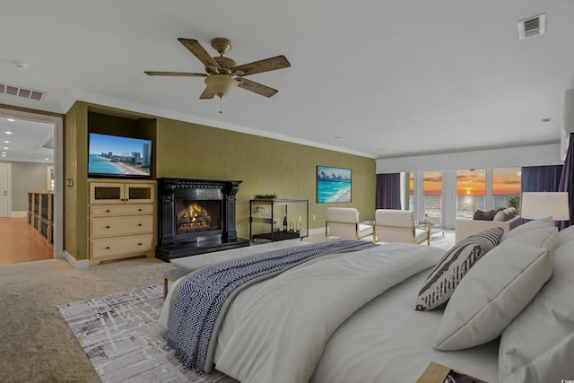 bedroom with crown molding, carpet floors, and ceiling fan